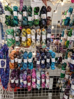 Indie dyed yarn hanging at a fiber festival